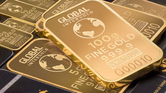 A detailed shot of gold bars labeled 'Global Intergold' as a symbol of wealth and investment.