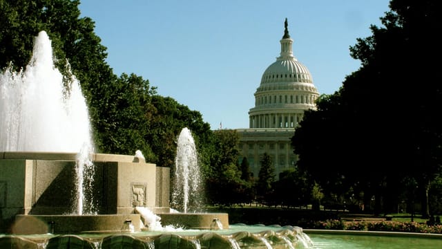 A stunning image of the US Capitol building with a foreground fountain in Washington D.C.