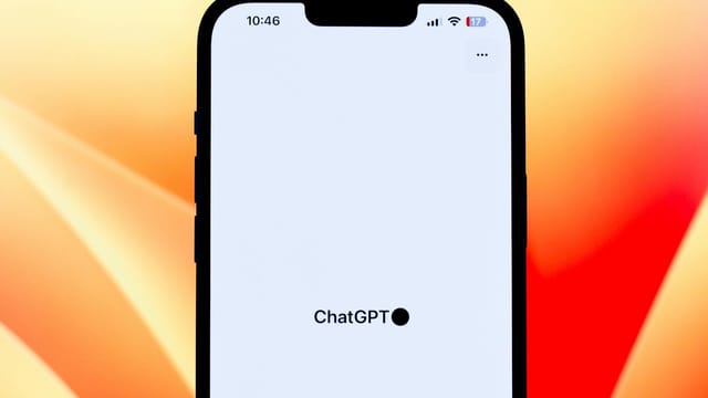 Close-up view of a smartphone showcasing the ChatGPT app against a colorful background.