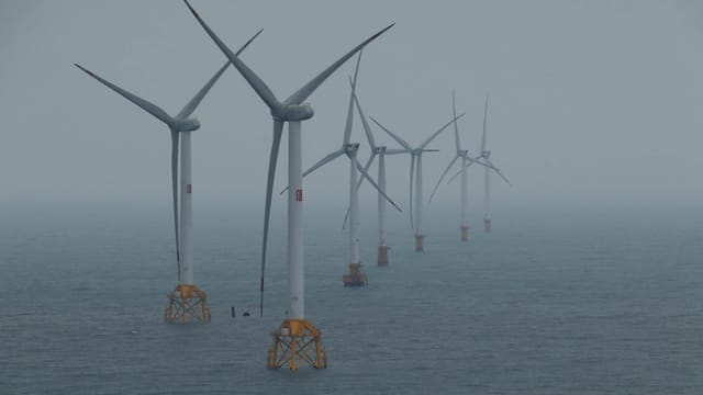 Offshore wind turbines generating clean energy in the ocean breeze.