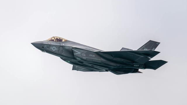 A state-of-the-art military stealth fighter jet soaring through the sky.