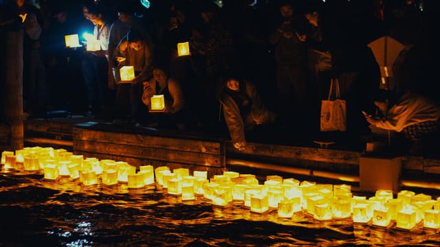 A serene night scene of floating lanterns during a festival in Saint Clair, Michigan.