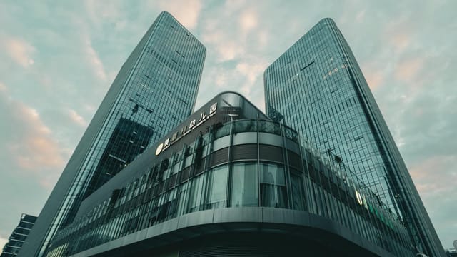 A striking view of modern skyscrapers in Shenzhen, China under a morning sky, showcasing stunning architecture.