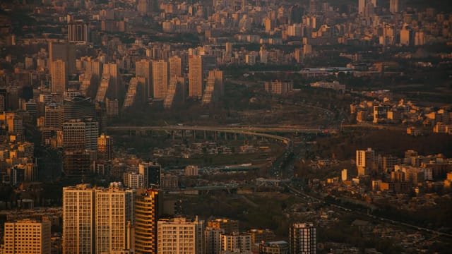 Stunning panoramic view of Tehran's skyline at dusk, showcasing the city's dense urban environment and architectural diversity.