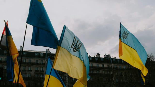 Ukrainian flags waving in a city square, symbolizing patriotism and freedom.
