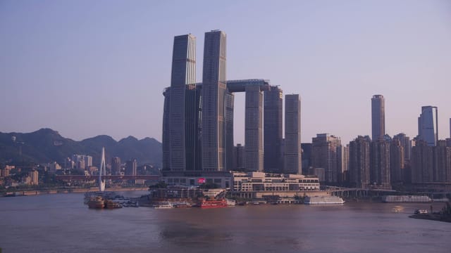 Captivating view of Raffles City and skyline by the Yangtze River in Chongqing, China.