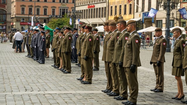 Polish soldiers in uniform standing in formation during a parade in Wrocław, Poland.
