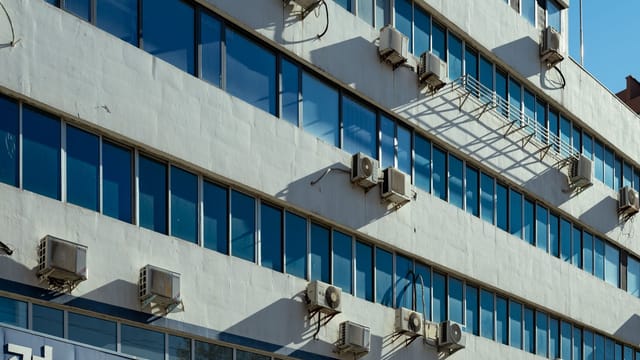 Exterior of urban building with air conditioners on the facade in Luoyang, China.
