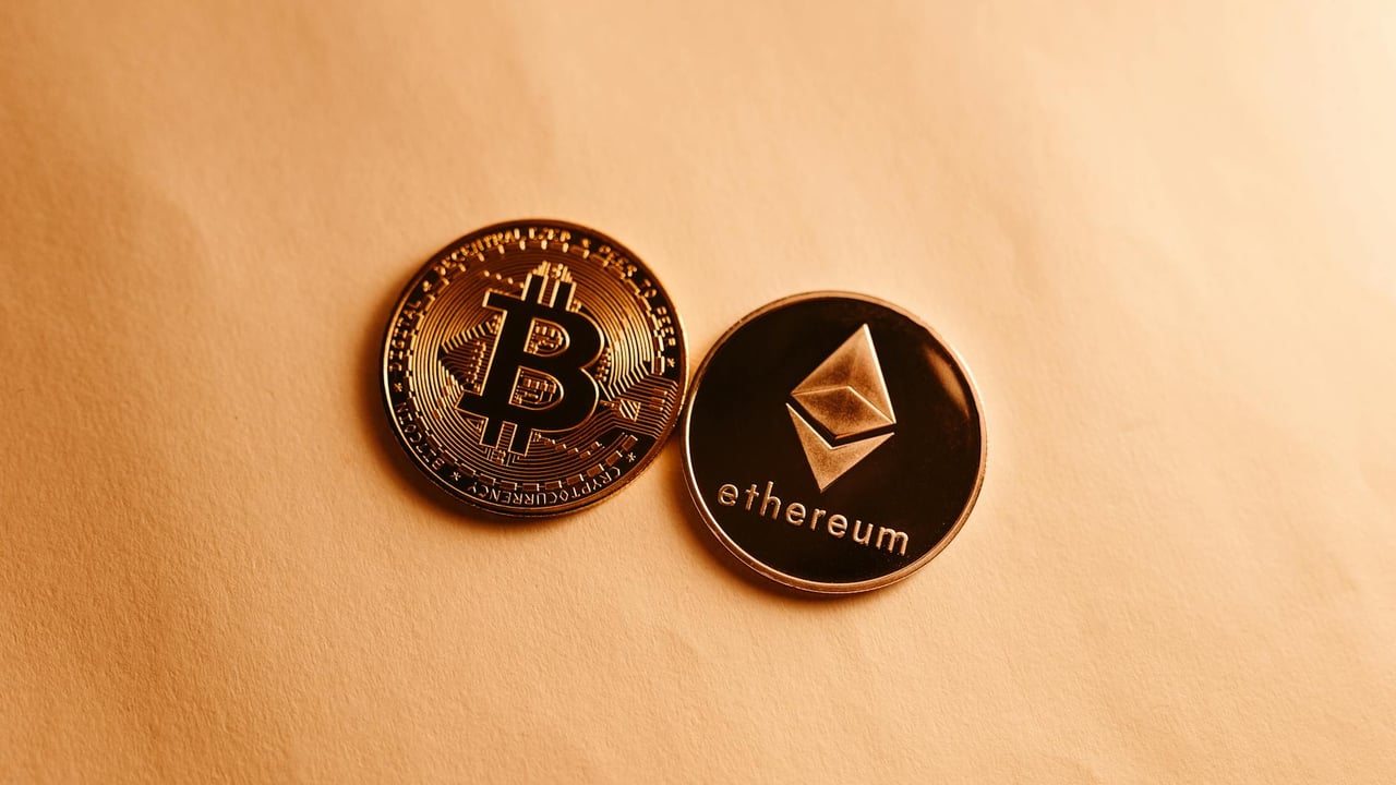 Bitcoin and Ethereum coins depicted on a soft yellow background for cryptocurrency and finance themes.