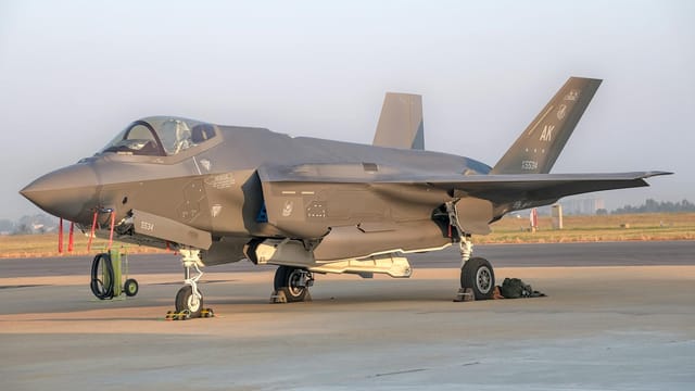 Military fighter jet on display outdoors at Bengaluru air show.