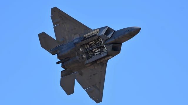 A powerful fighter jet soars through the clear blue sky, showcasing strength and speed.