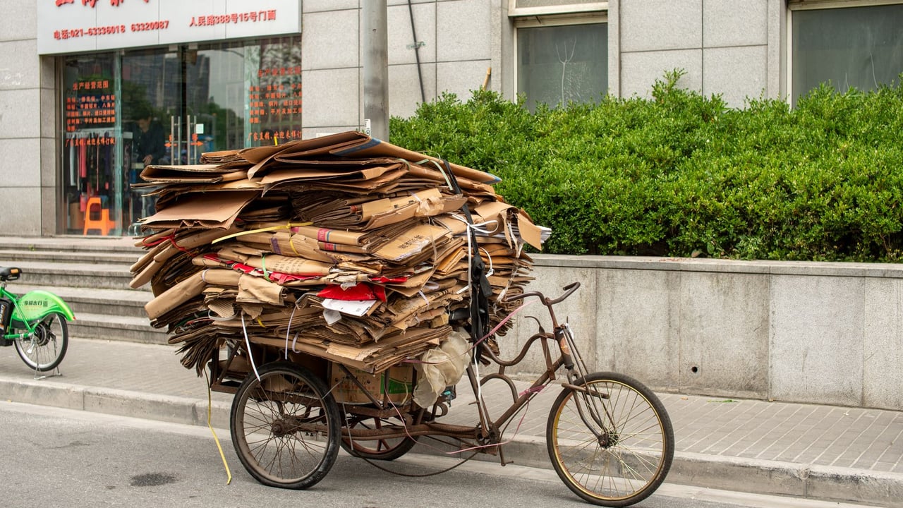 A tricycle loaded with cardboard boxes for recycling on a street in Shanghai, China.