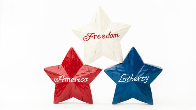 Red, white, and blue star decorations with 'Freedom,' 'America,' and 'Liberty' for a patriotic theme.