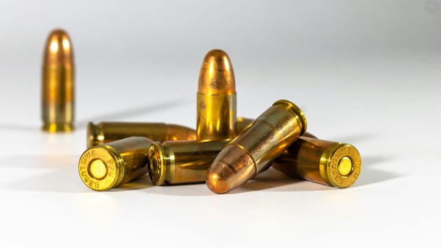 A still life of bullets displayed on a white background, highlighting their metallic texture and shape.