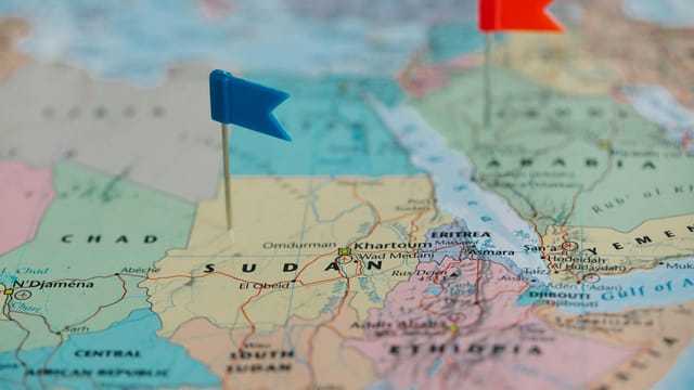 Detailed close-up map of Africa featuring Sudan and nearby countries marked with flags.