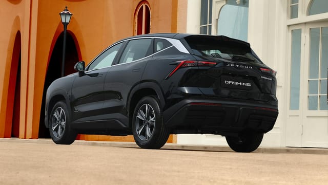 Elegant black SUV parked in a modern urban environment, showcasing luxury and style.