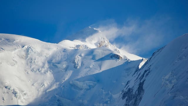 Breathtaking view of Mont Blanc's snow-covered peaks under a clear blue sky.