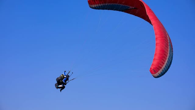 Exciting paragliding experience in Danyang-gun, South Korea under clear blue skies.