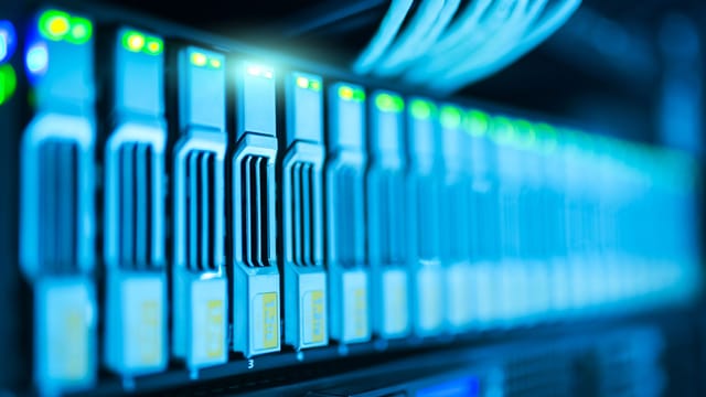 Illustrative image: Detailed image of a server rack with glowing lights in a modern data center.