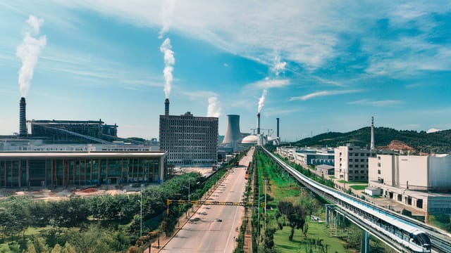 Aerial view of Jiujiang industrial area with factories and smoke stacks.