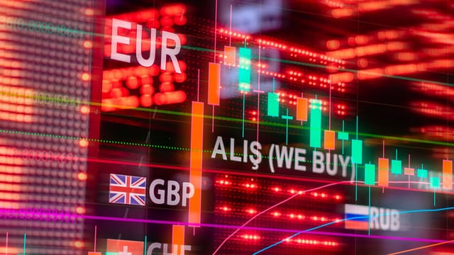 Dynamic forex trading concept with currency symbols and candlestick chart illuminated on screen.