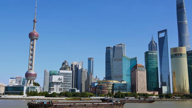 View of Shanghai's iconic skyline featuring the Oriental Pearl Tower and modern skyscrapers.