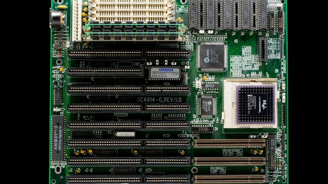 A close-up of a vintage motherboard highlighting microchips and electronic components.