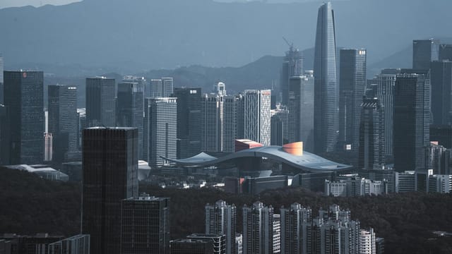 Stunning aerial view of Shenzhen's modern skyline with iconic skyscrapers at dusk.