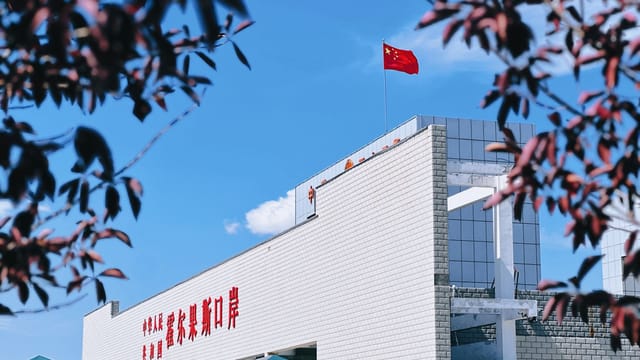 A view of Korghos Port featuring the Chinese flag on a sunny day.