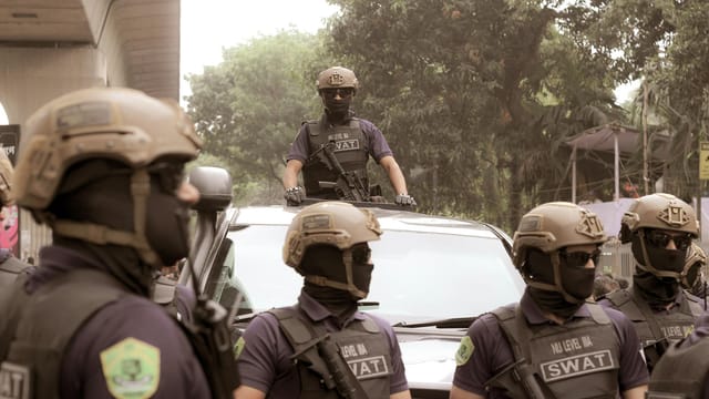 SWAT team on alert during a security operation in Dhaka, showcasing tactical gear and coordination.