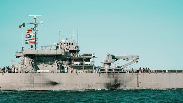 A navy warship sailing in the ocean near Veracruz, Mexico, with flags flown high.