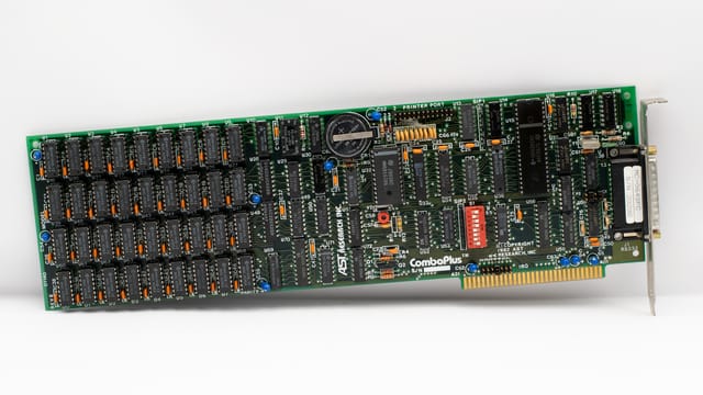 Close-up of a vintage computer circuit board featuring various electronic components.