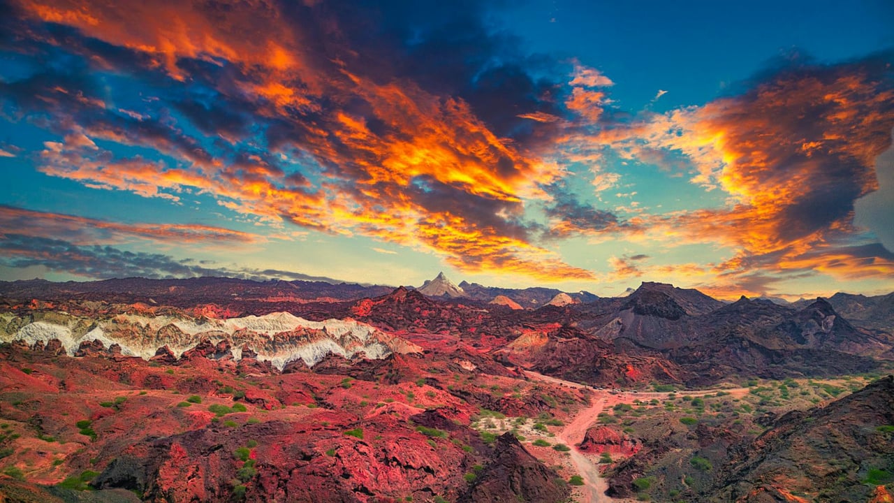 A stunning sunset over the vibrant rocky formations in Iran, showcasing natural beauty and dramatic skies.