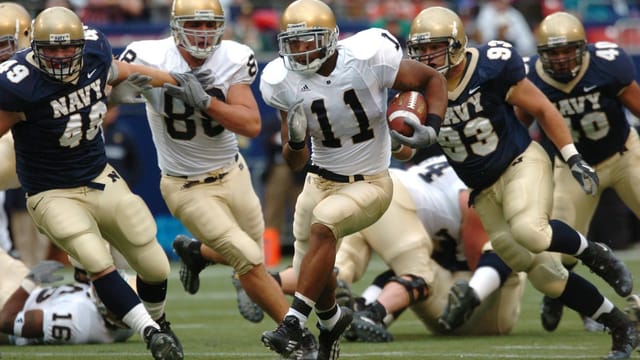 Players in action during a competitive American football game outdoors.
