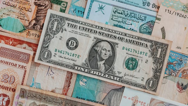 Top view of assorted paper money with American greenback representing image of President and numbers with words and signature on bill