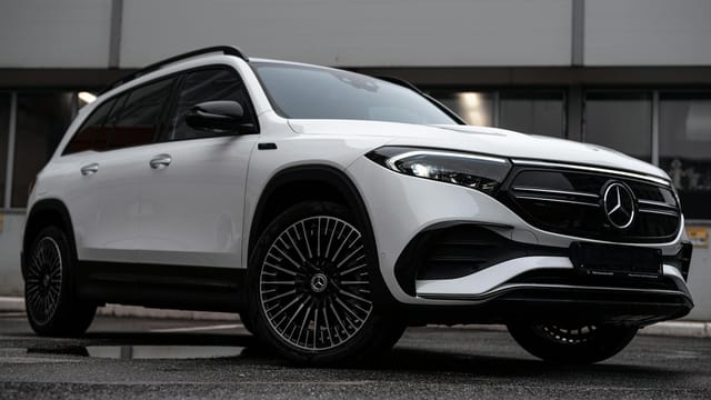 Sleek white Mercedes-Benz EQB SUV parked in a modern urban location.