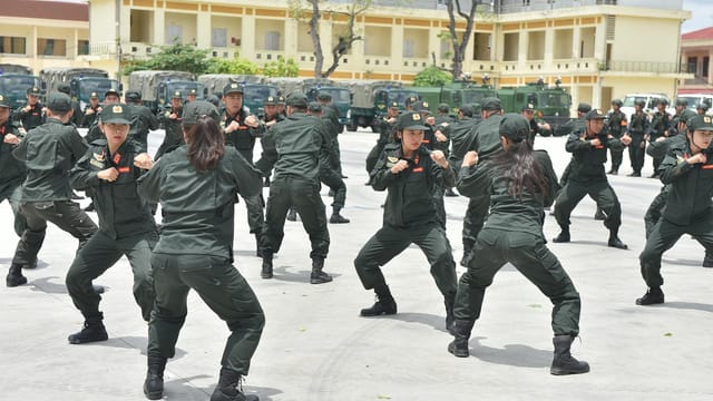 Soldiers participating in a coordinated outdoor training drill, displaying discipline and teamwork.