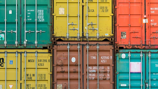 Illustrative image: Vibrant cargo containers stacked in a shipping yard highlighting global trade.