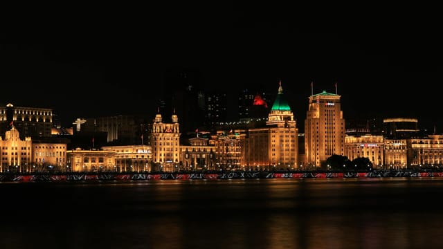 Stunning night view of Shanghai's Bund, showcasing illuminated historic buildings along the waterfront.
