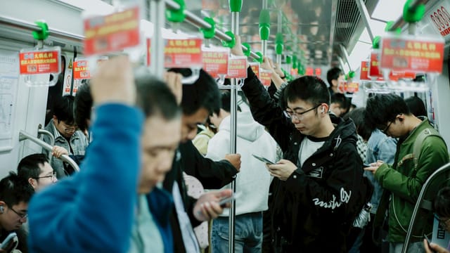 A candid scene inside a busy subway train in Nanjing, China, capturing daily urban life.