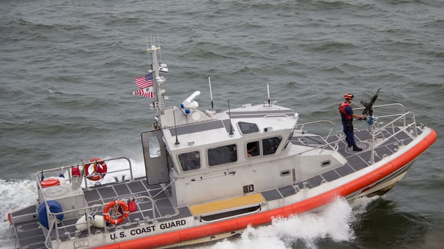 A U.S. Coast Guard boat patrolling ocean waters, showcasing marine security.