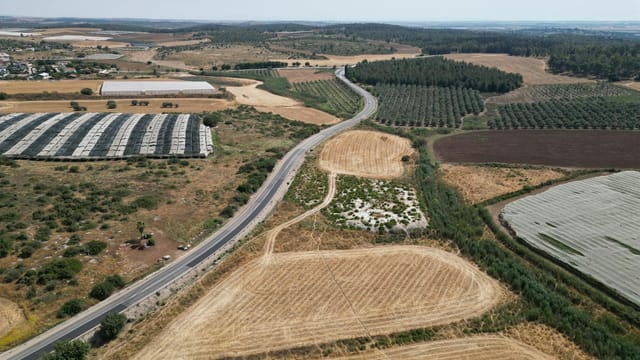 Aerial shot showcasing farmlands and roads in Gefen, Jerusalem District, Israel.