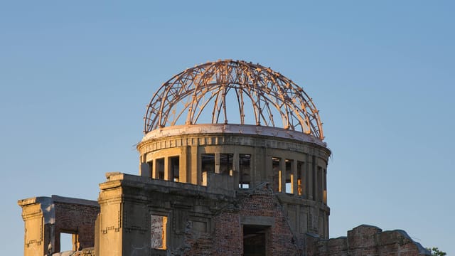 A solemn view of the Hiroshima Atomic Bomb Dome at sunset, symbolizing peace and resilience.