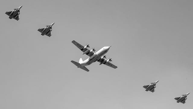 Black and white image of an Indian Air Force formation flight over New Delhi, India.