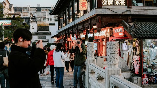 Capture of daily life in Nanjing's traditional shopping district, showcasing vibrant culture and architecture.