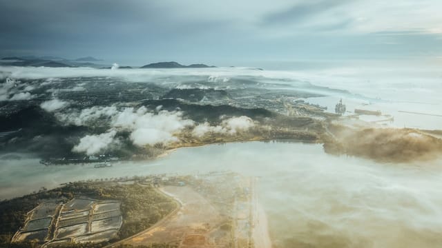 A stunning aerial view of Chukai, Terengganu's coastline with clouds and sea.