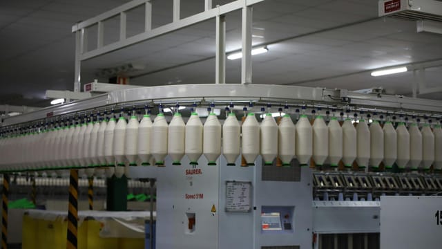 Industrial textile factory with yarn production line showcasing automated machinery for efficient manufacturing.