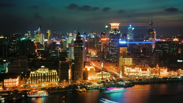 Illustrative image: A breathtaking view of Shanghai's illuminated skyline at night over the waterfront.