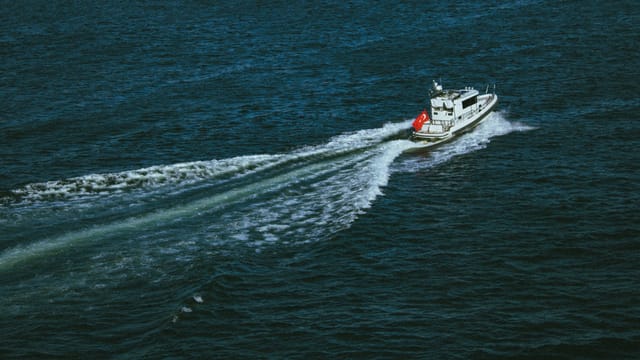 A boat travels on the Bosporus Strait, showcasing Istanbul's maritime culture.