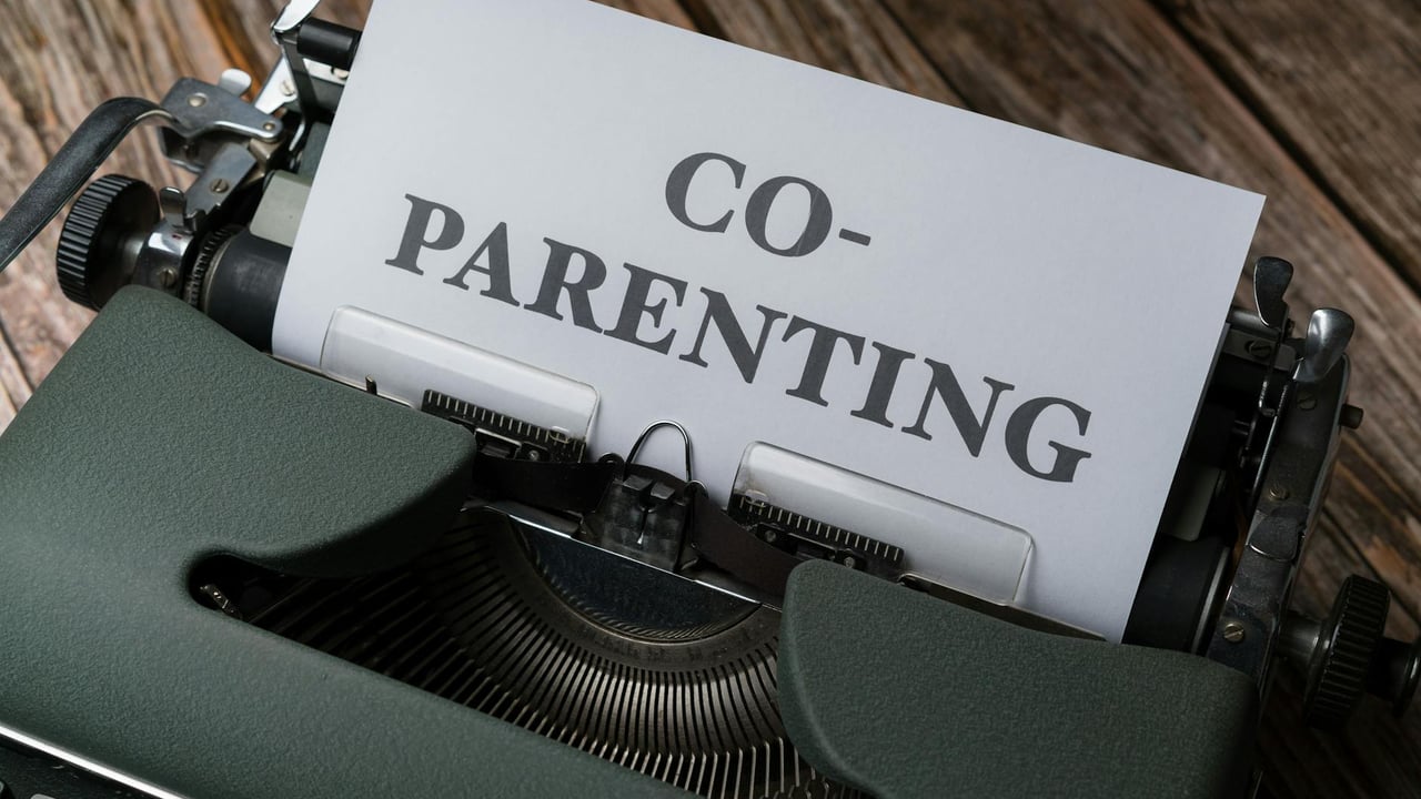 Close-up of a typewriter with a co-parenting document, symbolizing effective collaboration.